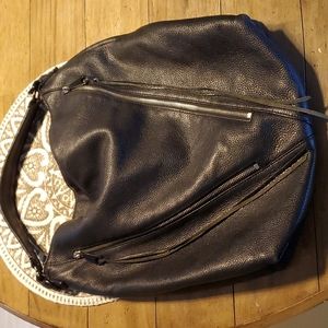 Rebecca Minkoff black purse with front zippers and leather tassels